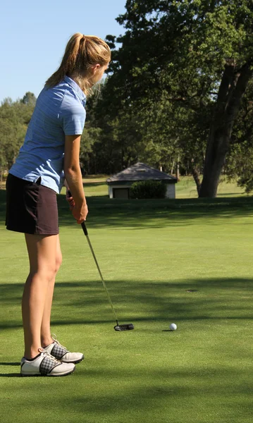 Mujer adolescente golfista poner en casa — Foto de Stock