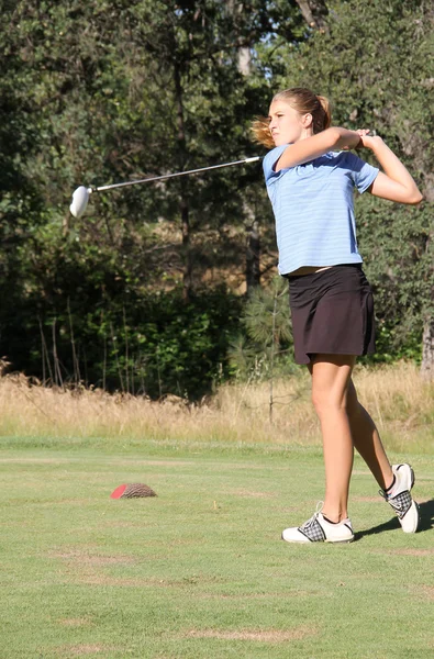 Female teen golfer after swing — Stock Photo, Image