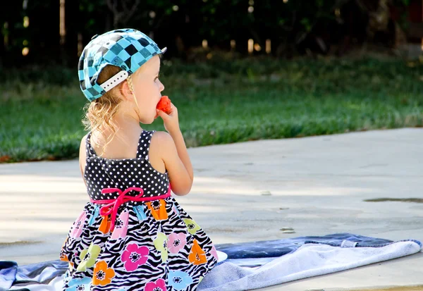 Toddler eating watermelon at pool — Stock Photo, Image