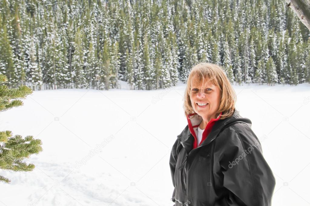 Senior female hiking near frozen lake
