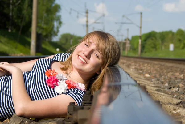 Beautiful girl lying on the rails — Stock Photo, Image