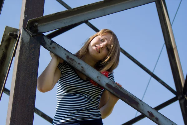 Beautiful girl sits on the iron — Stock Photo, Image