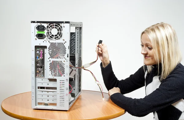 Girl repairing the system unit — Stock Photo, Image