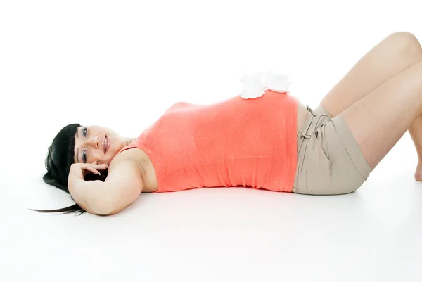 Pregnant girl lying with booties — Stock Photo, Image