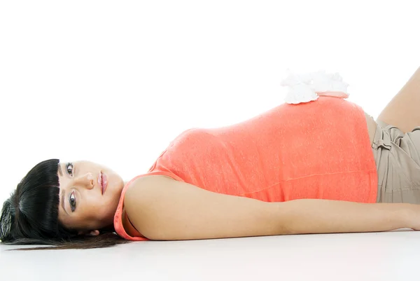 Pregnant girl lying with booties — Stock Photo, Image