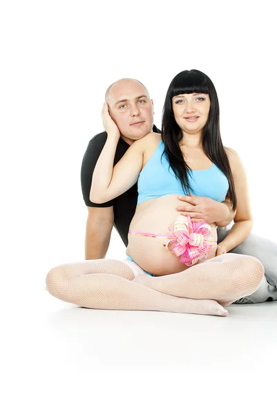 Husband and pregnant wife with ribbon Stock Image