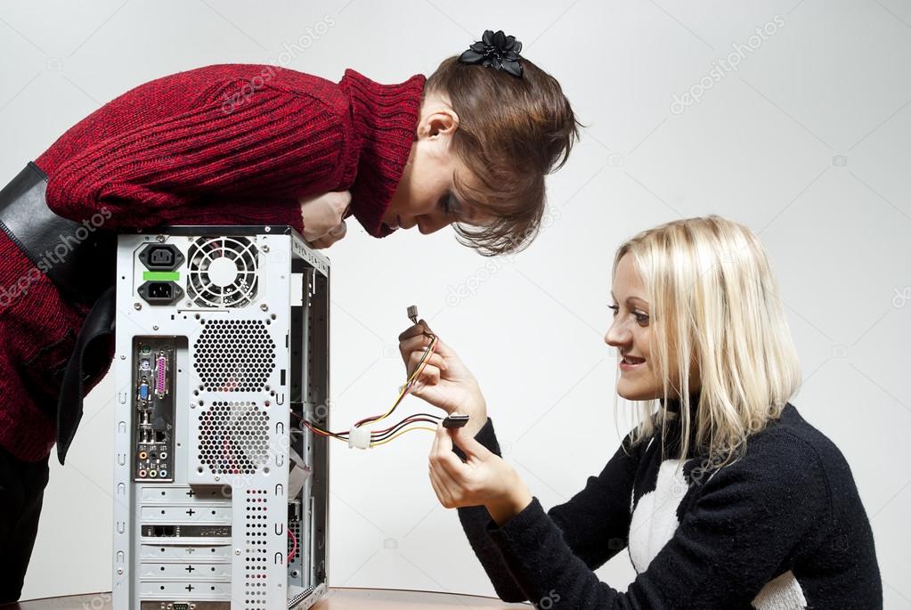 Beautiful girl repairing the system unit