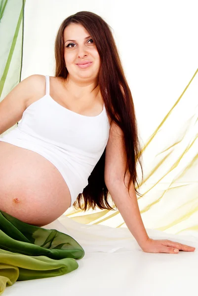 A pregnant girl in a green veil — Stock Photo, Image