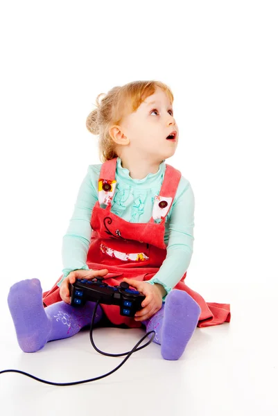 Little girl playing video games on the joystick — Stock Photo, Image