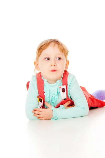 The little girl lying on the floor — Stock Photo, Image