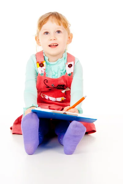 A little girl sits and paints Royalty Free Stock Images