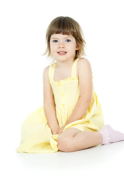 Bright little girl sitting isolated — Stock Photo, Image