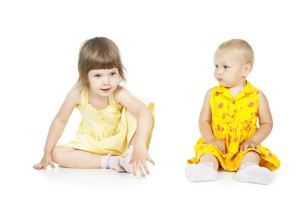 Two little girls sitting Royalty Free Stock Images
