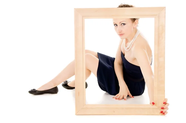 The girl looks in a frame — Stock Photo, Image