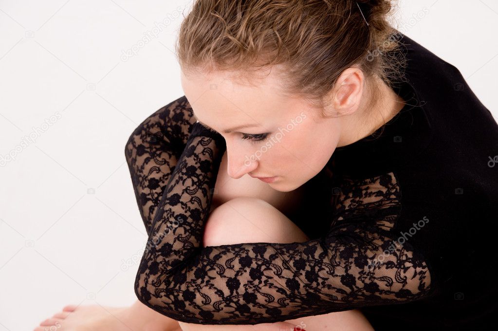 a girl sits and sad, upset