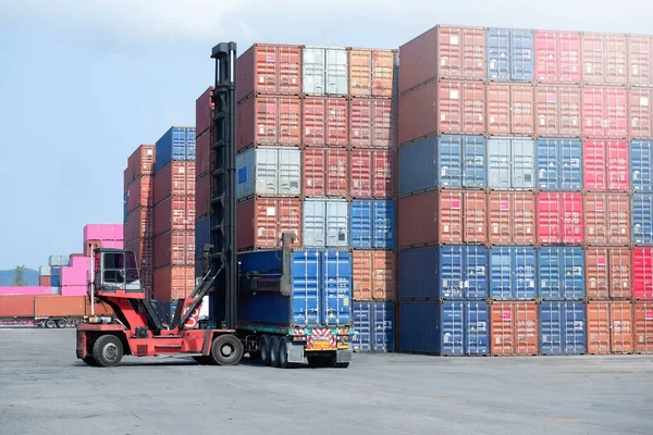 Container stacker, load the container into the truck. Transportation concept