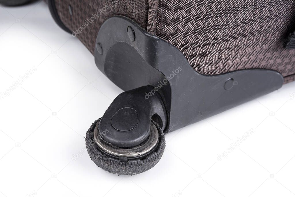 Worn out wheel on a rolling luggage trunk