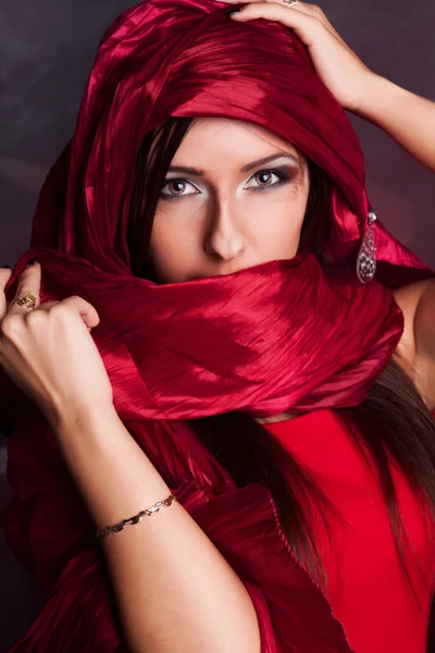 Beautiful girl in the eastern red kerchief — Stock Photo, Image