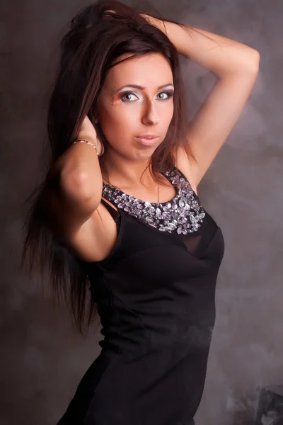 Beautiful girl in a black dress with sequins — Stock Photo, Image