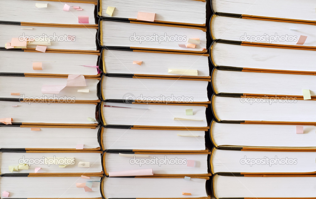 Stack of books with sticky notes