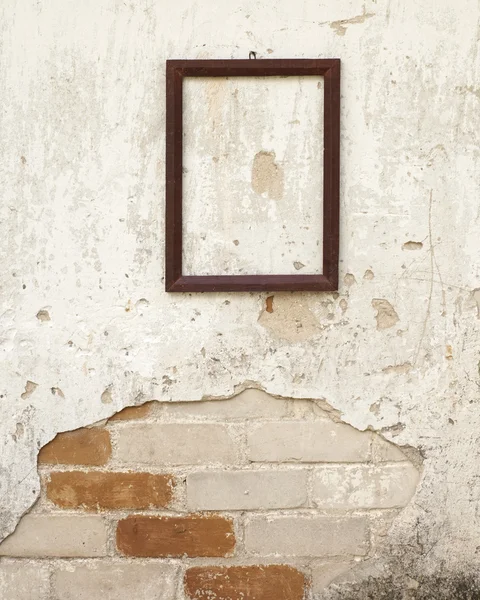 Houten frame aan de muur — Stockfoto
