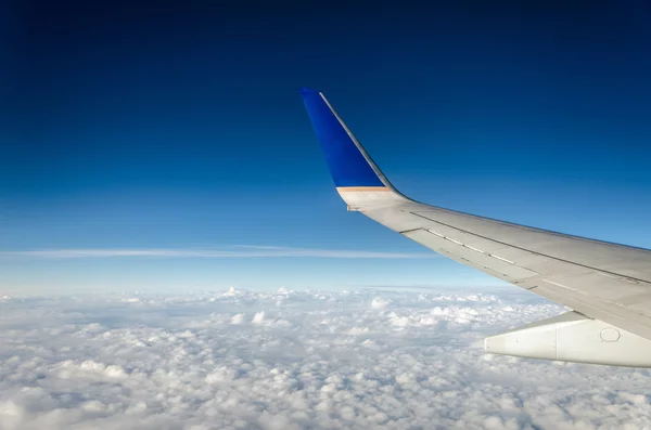 Airplane Wing and Clouds Stock Image