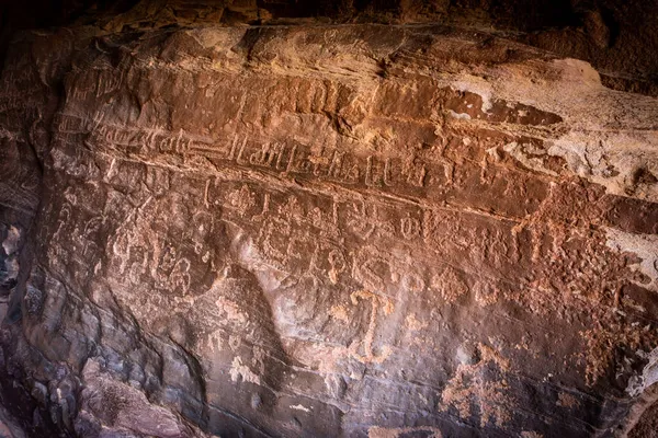 Ancient Arabic petroglyph writing in a canyon in Wadi Rum, Jordan