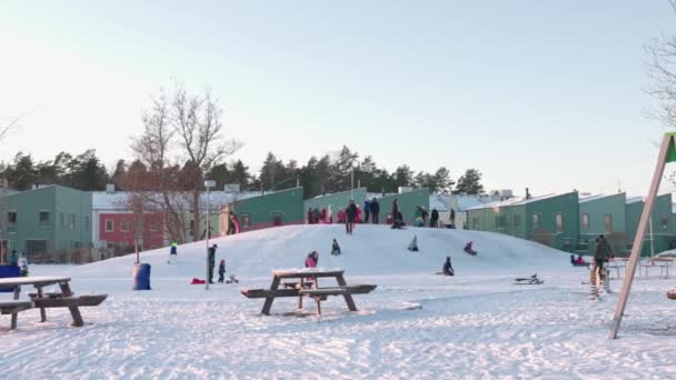 Snow Covered Hill Children Sledding Snowboarding Parents Cottage Village Sweden — 图库视频影像