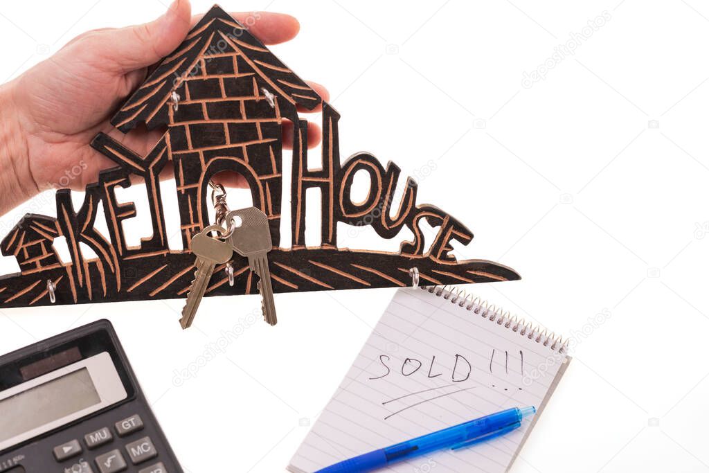 Close up of house symbol sale with keys isolated on white background. Sweden.