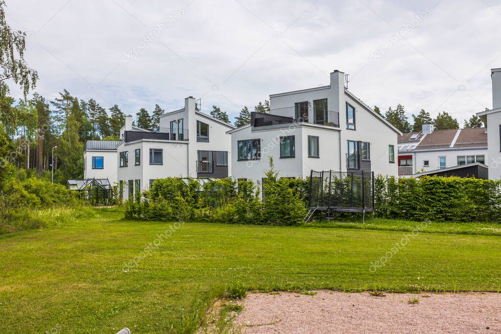Beautiful view of white modern village houses on outskirts of village. Sweden.