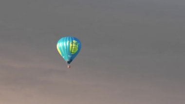 Beautiful view of air balloon with people in basket in stormy cloudy sky. Sweden. Uppsala. 05.11.2022.