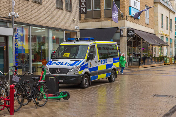 Beautiful view of tourist pedestrian area with shops and police car in downtown after rain. Sweden. Uppsala. 05.14.2022.