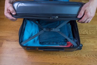 Bagajı kapatan adamın ellerini görebiliyoruz. Trip konsepti. İsveç. 