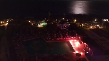 Beautiful view of hotel grounds with entertainment program fire show in front of tourists. Time Lapse. Rhodes. Greece.