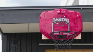 View of basketball practice where ball is thrown into basket with net in yard of private house. Sweden. Uppsala. 07.30.2022.