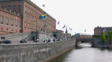 Beautiful view of Swedish and Finnish flags on square near Royal Palace in center of Stockholm against backdrop of Baltic Sea. Sweden. Stockholm. 05.18. 2022.