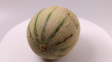 Close up view of Cantaloupe melon isolated on background.