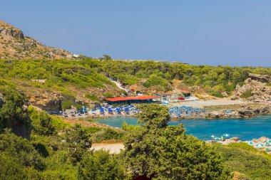 Beautiful view of hotels beach area equipped with sun beds and umbrellas on island's coastline. Rhodes. Greece. 