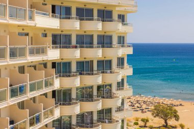 Beautiful view of part of hotel overlooking grounds and beach in Mediterranean sea. Rhodes. Greece. 07.15.2022.