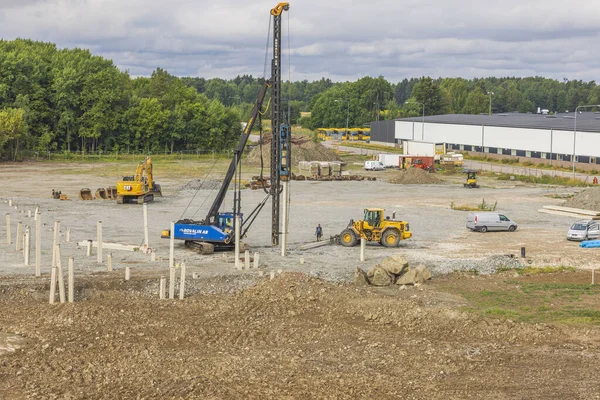View of building machines in process of driving piles at construction area. Sweden. Enkoping. 08.05.2022.