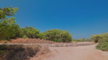 Beautiful view of nature with rock road in mountains between dwarf mountain pines. Greece.