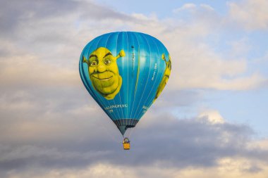 View of Shrek hot air balloon in cloudy blue sky. Sweden. Uppsala. 05.10.2022.