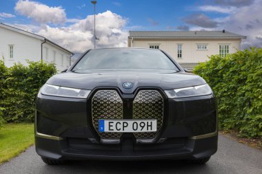Beautiful e terior view of BMW iX40 on parking spot of private home. Sweden. Uppsala. 08.18.2022.
