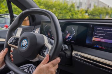 Close up view of woman's hands on steering wheel of new BMW iX40. Sweden. Uppsala. 08.18.2022.