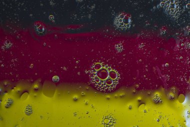 Close view of underwater texture abstract design black, red and yellow colors.