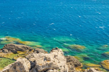 Beautiful view of rocky coast on turquoise water background in sea. Greece.