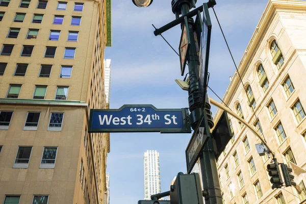 Beautiful cityscape view of buildings tops on blue sky background. Sign of West 34th Street.  New York. USA.