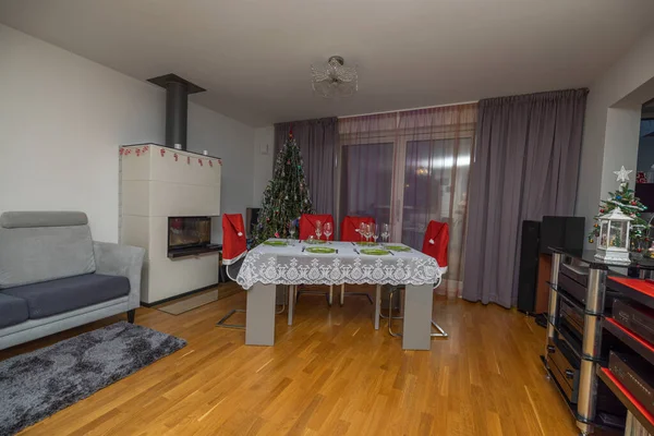 Beautiful view of interior of room with furniture, hi-fi equipment, Christmas decorations and served table. Sweden.