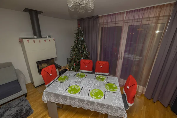 Beautiful view of interior of room with Christmas decorations and served table. Sweden.