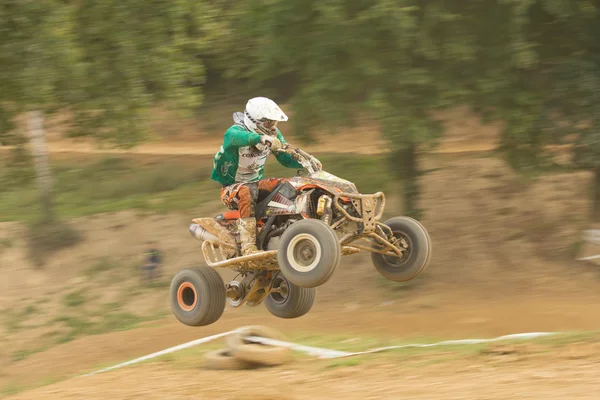 Young rider jumps the quad. Panning shot. — Stock Photo, Image